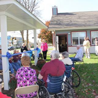 Seniors engaged in a community event outdoors, enjoying the sunny weather.