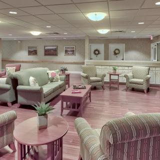A cozy and well-furnished living room with sofas, armchairs, and coffee tables arranged in an inviting layout.