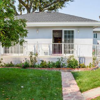A cozy residential house with a well-maintained lawn and garden path.