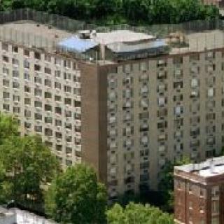 Aerial view of a residential apartment building surrounded by trees.