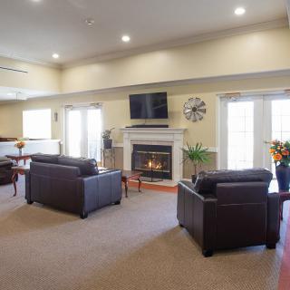 A cozy living room with a fireplace and comfortable seating.