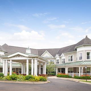 A large building with a welcoming entrance and landscaped surroundings.