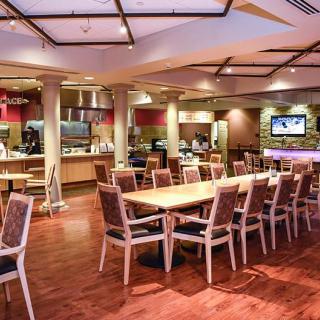 A modern restaurant dining area with neatly arranged tables and chairs.