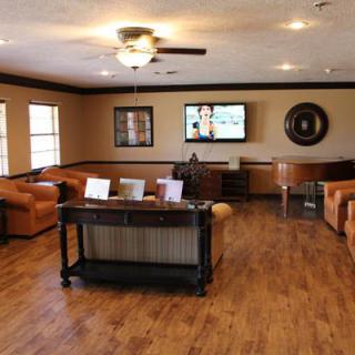 A spacious living room with comfortable seating and a modern entertainment setup.
