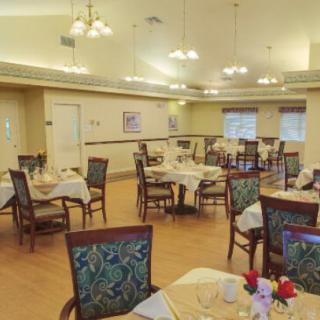 An elegantly decorated dining room with multiple tables set for guests.