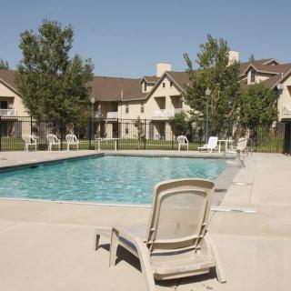 A serene outdoor swimming pool surrounded by residential apartments, perfect for relaxation.