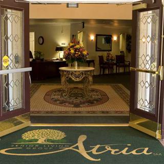 Entrance to a building with a welcoming lobby and a decorative mat.