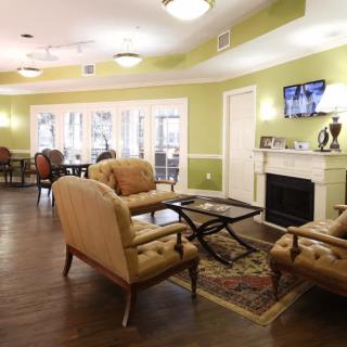 A cozy living room interior with comfortable seating and a fireplace.