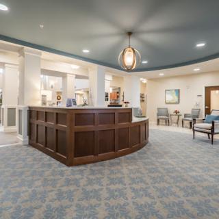 A modern hotel lobby featuring a welcoming reception desk and comfortable seating areas.
