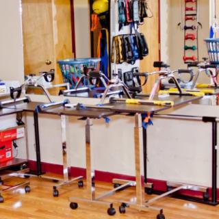 A gym room equipped with stationary bikes and fitness gear.