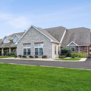 A suburban residential house with a well-maintained lawn.