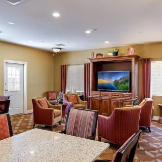A cozy living room with comfortable seating and a large TV, perfect for relaxation.