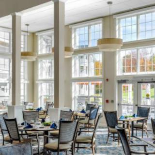 A modern dining area with large windows allowing natural light to fill the room.