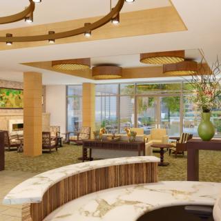 A modern hotel lobby with elegant furnishings and natural lighting.