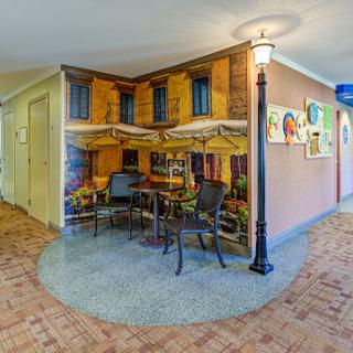 A creatively designed interior featuring a caf mural that gives the illusion of a charming outdoor dining space.