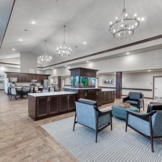 A modern lobby with elegant chandeliers and comfortable seating.