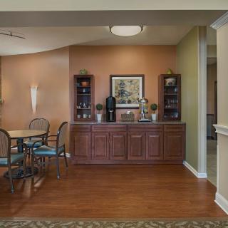 A comfortable dining area with wooden flooring and elegant decor.