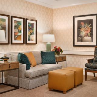 A cozy living room with a sofa, artwork, and stylish decor.
