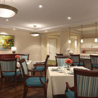 An elegant dining room with neatly arranged tables and chairs, featuring soft lighting and tasteful decor.