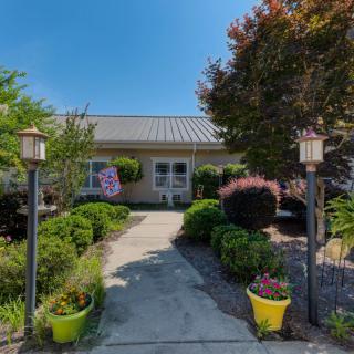 A charming house with a beautifully landscaped garden and pathway.