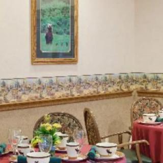 A well-decorated dining area with neatly set tables and wall artwork.