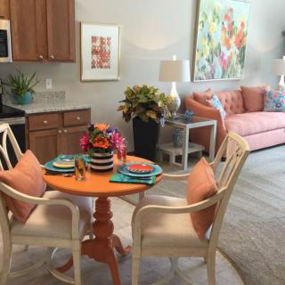 A cozy open-plan living and dining area featuring colorful decor and comfortable seating.