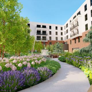 A beautifully landscaped garden with a winding pathway in an urban apartment complex.