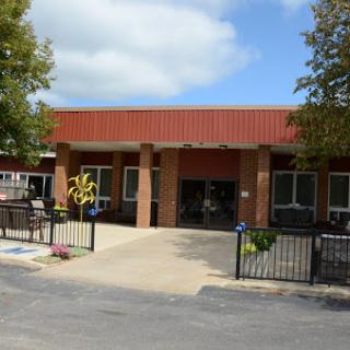 View of a commercial building with landscaped entrance.