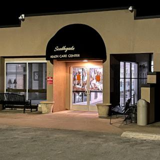 A well-lit storefront at night, welcoming customers with its illuminated entrance.