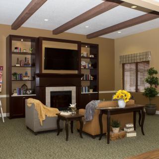 A cozy living room with a fireplace, television, and comfortable seating area.