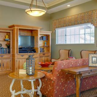 A cozy living room with comfortable seating, a television, and decorative furnishings.