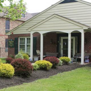 A charming front view of a house with a well-maintained garden and porch.