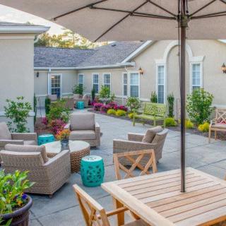 A cozy outdoor patio area with seating and greenery.