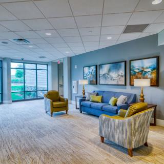 A modern lobby with comfortable seating and large windows.