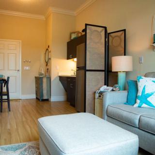 A cozy living room with a stylish sofa, lighting, and elegant decor.