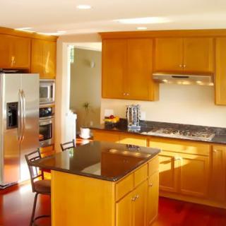 A modern kitchen with wooden cabinets and a central island.