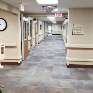 A clean and well-lit corridor in a hospital or office environment.
