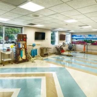 A spacious hospital lobby with modern design and medical equipment in view.
