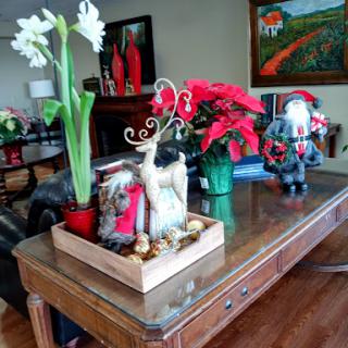 A cozy holiday-themed table arrangement featuring vibrant flowers and festive decorations.