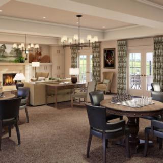 A cozy living and dining area with elegant chandeliers, comfortable seating, and a warm fireplace.