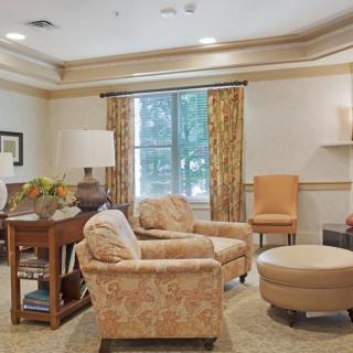 A cozy living room with armchairs, a coffee table, and elegant decor.