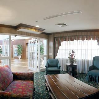 A cozy lobby area with comfortable seating and large windows.