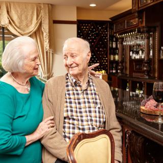 An elderly couple sharing a happy moment together in their cozy home.