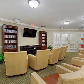 Comfortable seating area with a television and bookshelves.