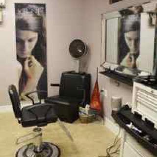 A hair salon interior with styling chairs and mirrors.