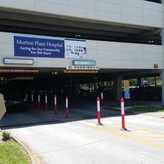 Entrance to a hospital parking garage with clear signage.