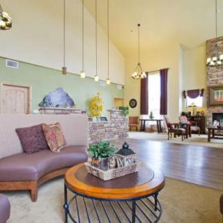 A spacious and cozy living room with comfortable seating, a stylish coffee table, and elegant lighting.