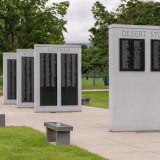 A memorial dedicated to honoring the deceased, featuring several plaques listing names.