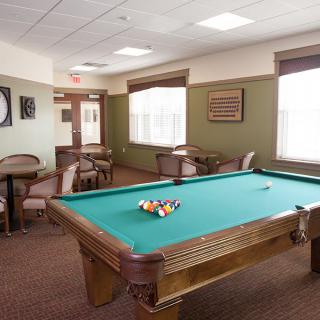 A cozy game room featuring a pool table and seating area.