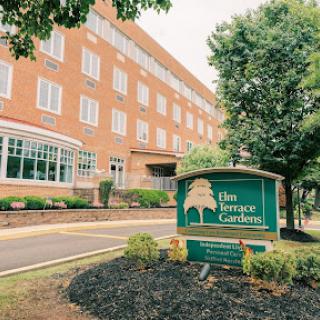 The exterior view of The Terrace Gardens, showcasing its welcoming entrance and beautifully landscaped surroundings.